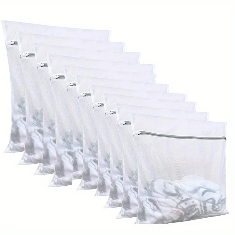 A stack of clear mesh laundry bags filled with white fabric, arranged in a row.