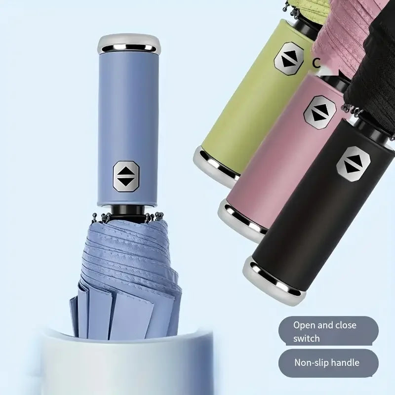 A close-up view of an automatic three-fold umbrella with a non-slip handle and various colored fabric sleeves.