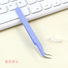 A light purple precision craft tweezers with straight and curved tips resting on a white keyboard.