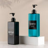 A set of three dark green and blue refillable soap dispenser bottles with black pump tops displayed on a white surface.