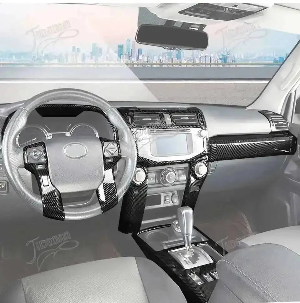 Interior view of a Toyota 4Runner showing the steering wheel and dashboard with carbon fiber trim.