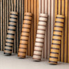 Roll of striped peel-and-stick wallpaper in brown and beige tones displayed vertically.