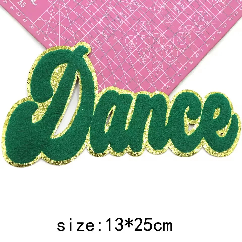 Green felt letter patch spelling 'Dance' with gold glitter outline