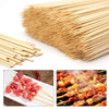 A large bundle of natural bamboo skewers for BBQ and grilling, showing various lengths and angles.