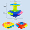 A set of glowing musical spinning tops for kids party favors in yellow, blue, and orange colors.