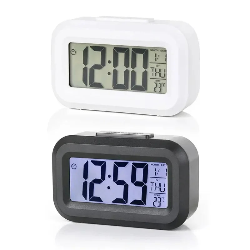 A white compact LED digital alarm clock displaying 12:00 and temperature, shown next to a black version.