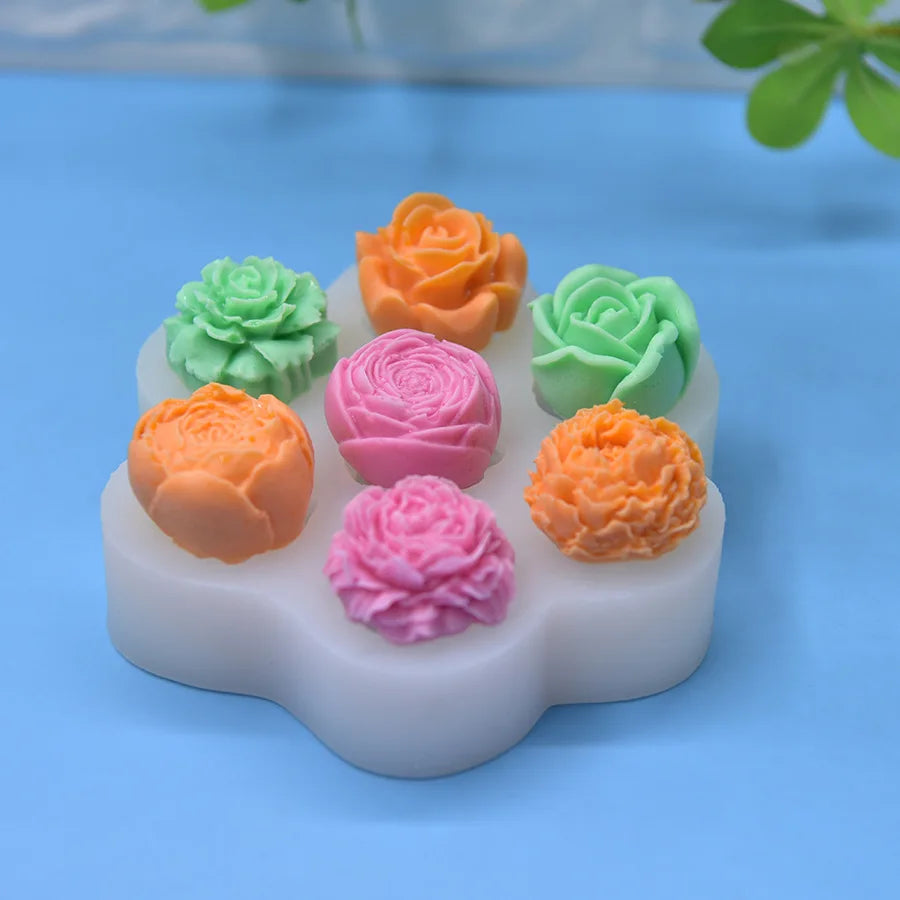 A set of silicone molds shaped like various colored roses and succulents for DIY crafts