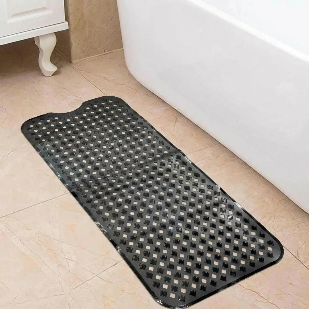 A black non-slip bathtub mat with a grid pattern and suction cups placed on a tiled floor next to a white bathtub.
