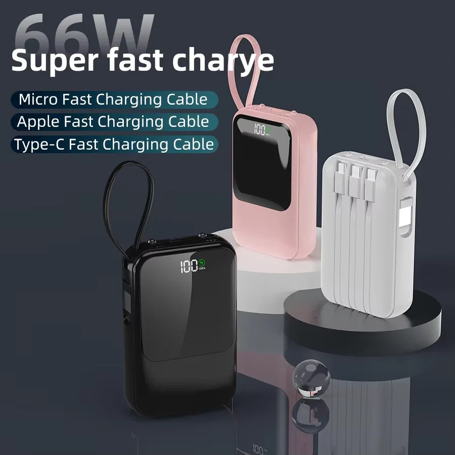 Pinkes und weißes tragbares Powerbank mit verschiedenen Ladekabeln auf dunkler Oberfläche