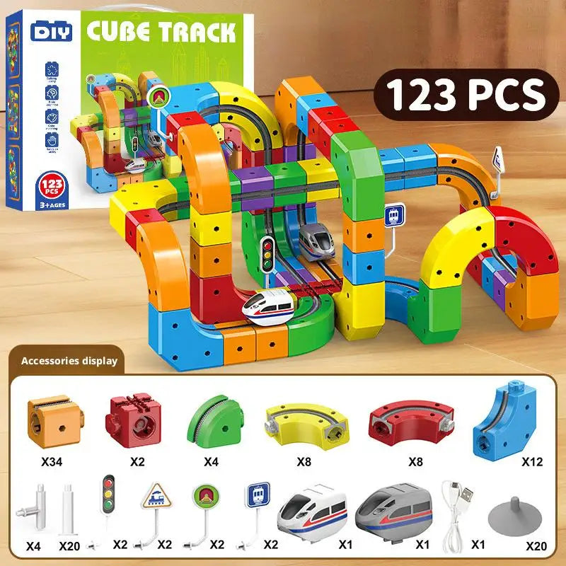 A box of 123 pieces of Cube Track building blocks and accessories for a STEM electric train set.