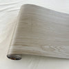 Roll of self-adhesive wood grain floor stickers in a light gray tone for waterproof peel-and-stick wallpaper.