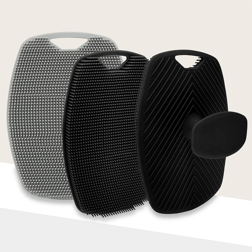 A set of two silicone body scrubbers or massage brushes, one silver and one black, shown against a light background.