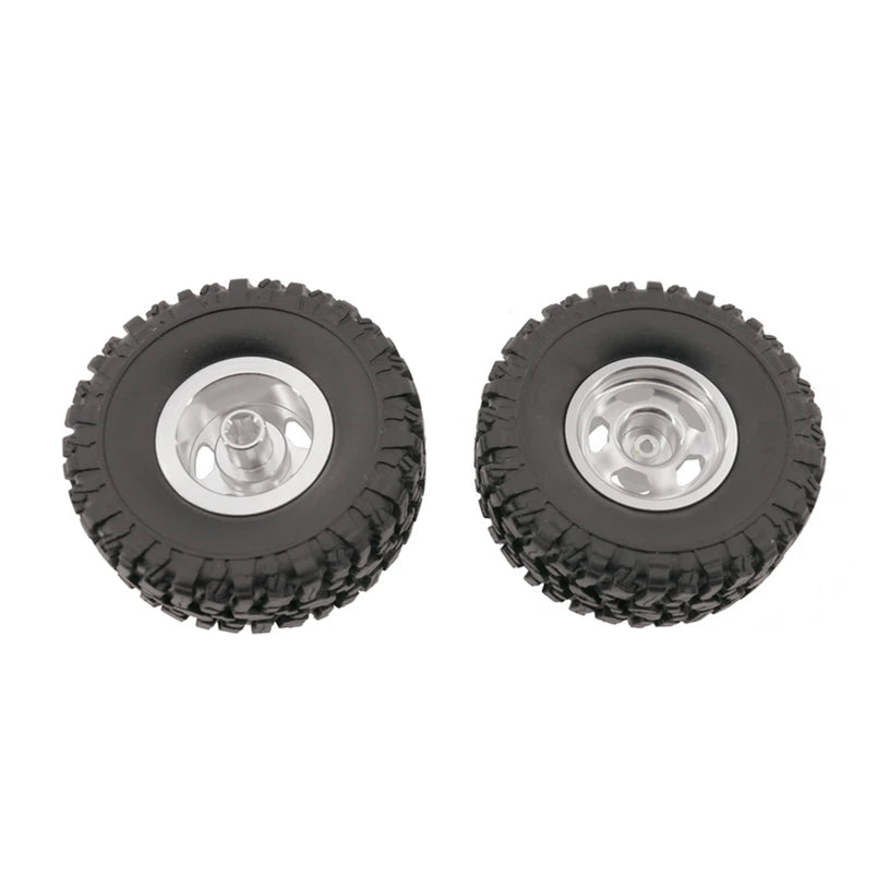 A pair of black RC car upgrade wheels with shiny metal rims and soft tires.