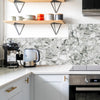 White marble self-adhesive wall tiles used as a backsplash in a modern kitchen