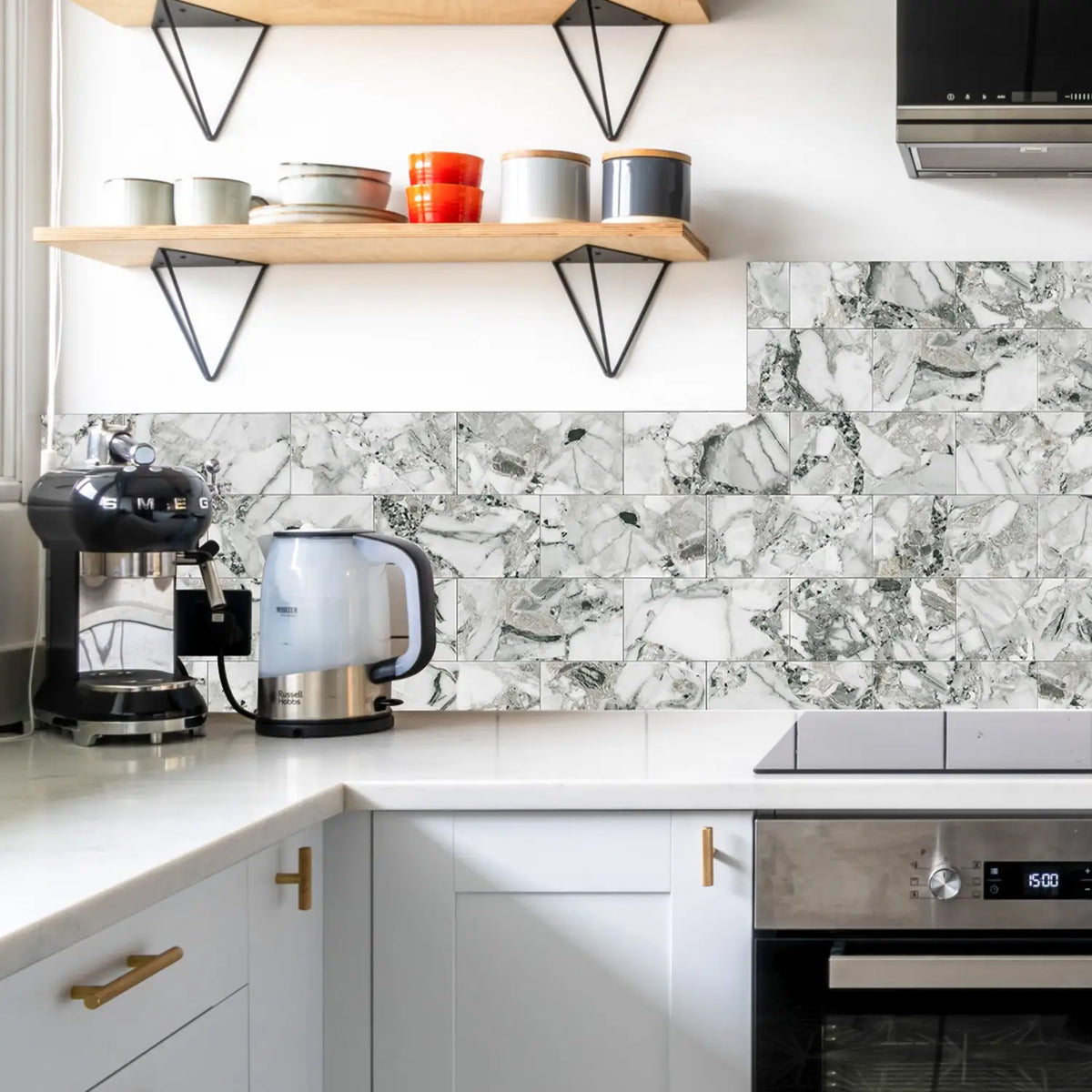 White marble self-adhesive wall tiles used as a backsplash in a modern kitchen