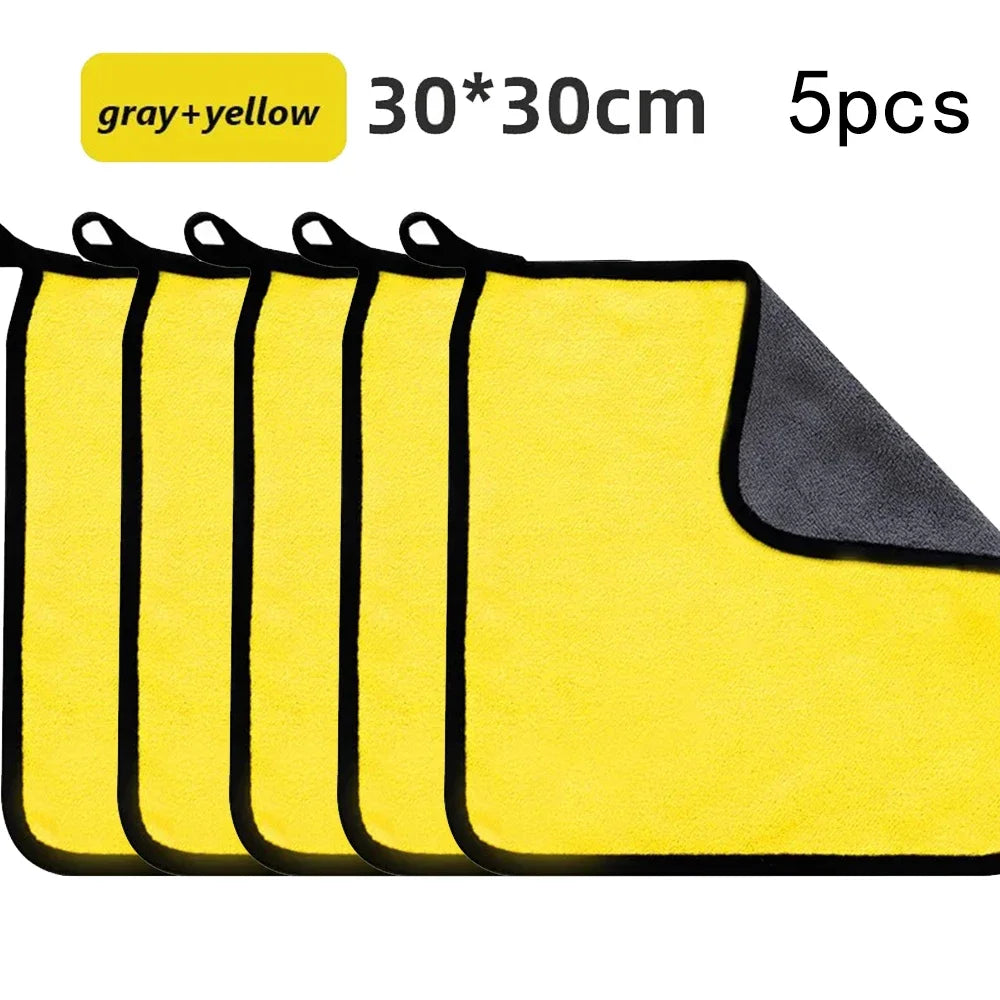 Five gray and yellow microfiber car cleaning towels stacked together.
