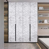 Modern vertical cabinet doors with white marble pattern on a light gray floor.