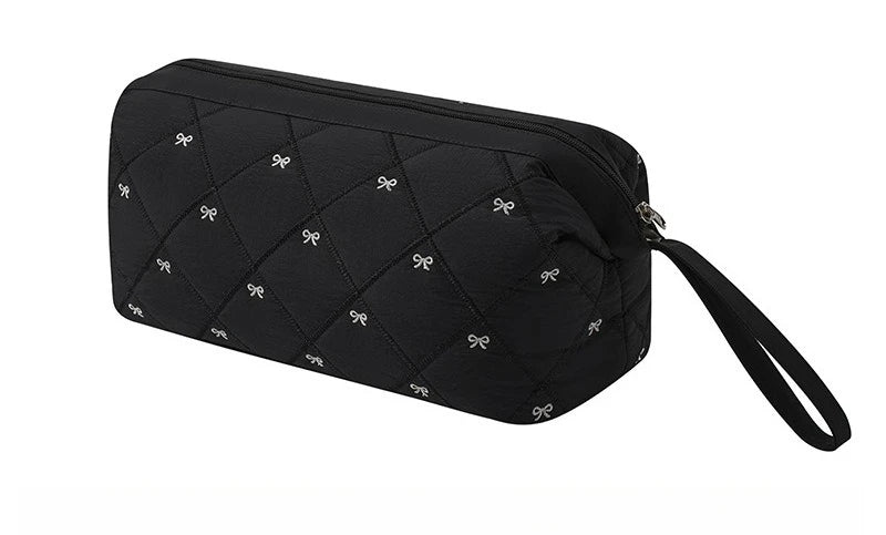 Black quilted storage bag for a portable hair dryer and styling tool.