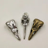 A set of five silver and brass gothic skull and crow head charms for jewelry making