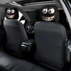 A set of two black smiley face car headrest cushion covers installed in a vehicle interior.