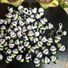 A pile of handmade crochet kitten keychains featuring cute panda and cartoon animal charms.