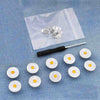 A silver instant no-sew snap button kit is displayed on a translucent pouch against a blue denim background.
