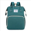 Teal backpack diaper bag with a light beige changing mat visible.