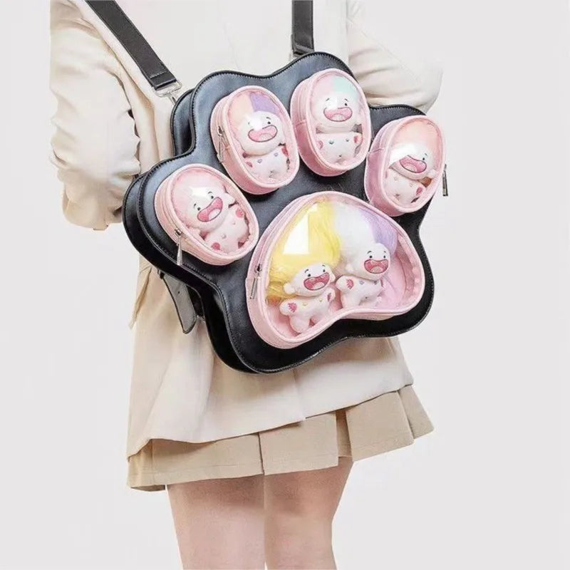 A pink Cat Paw Print multi-pocket backpack with several transparent pockets worn by a woman.