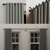 Close-up view of a classic iron curtain rod with ball finials in a matte gray finish.