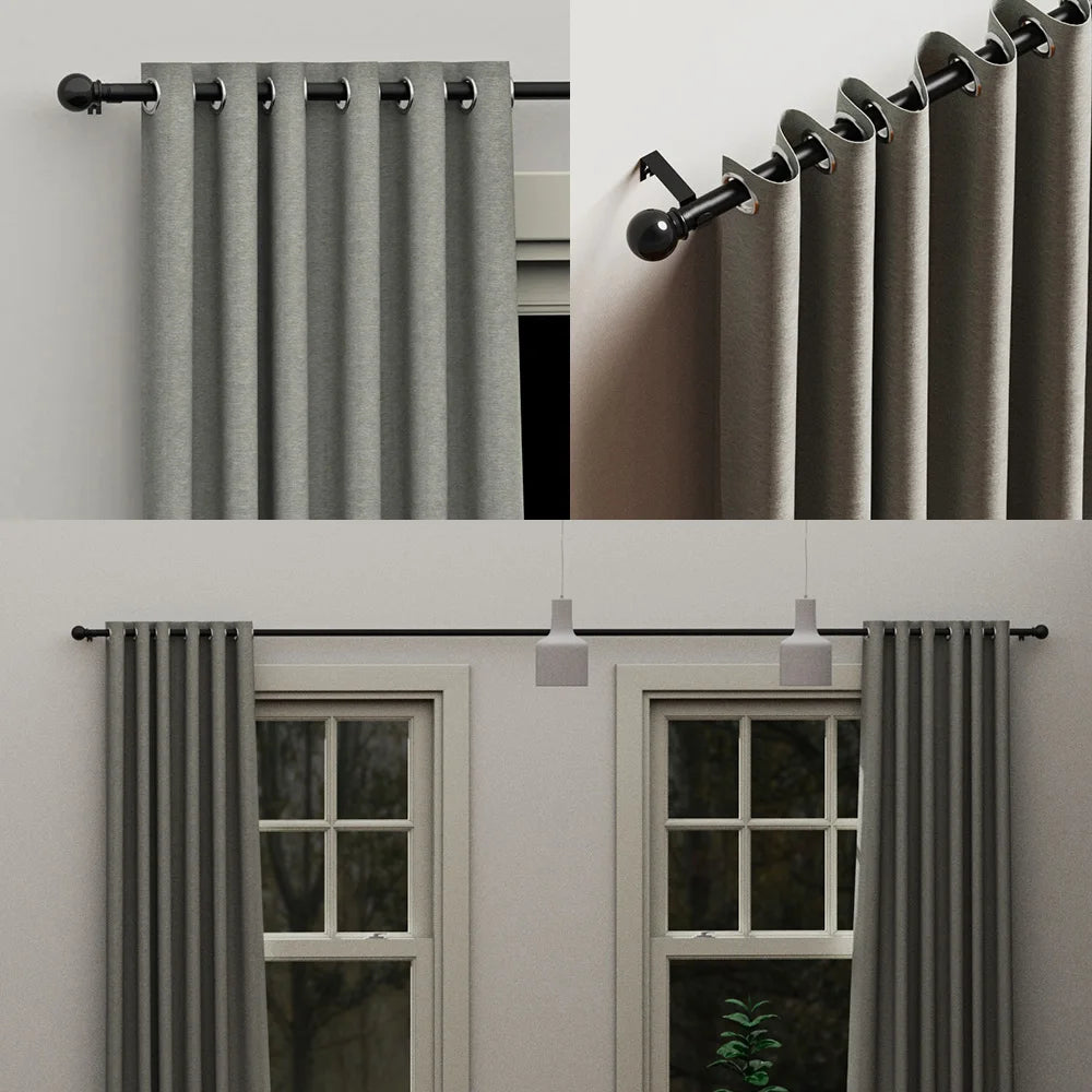 Close-up view of a classic iron curtain rod with ball finials in a matte gray finish.
