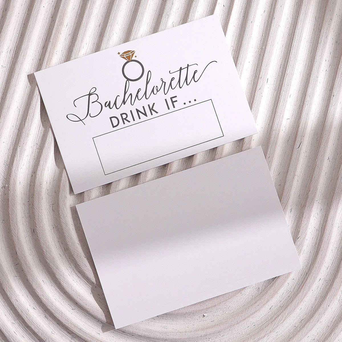 A white card with a gold ring graphic and the text Bachelorette DRINK IF