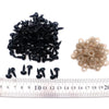 A pile of black safety noses with washers and a row of light tan noses measured against a ruler.