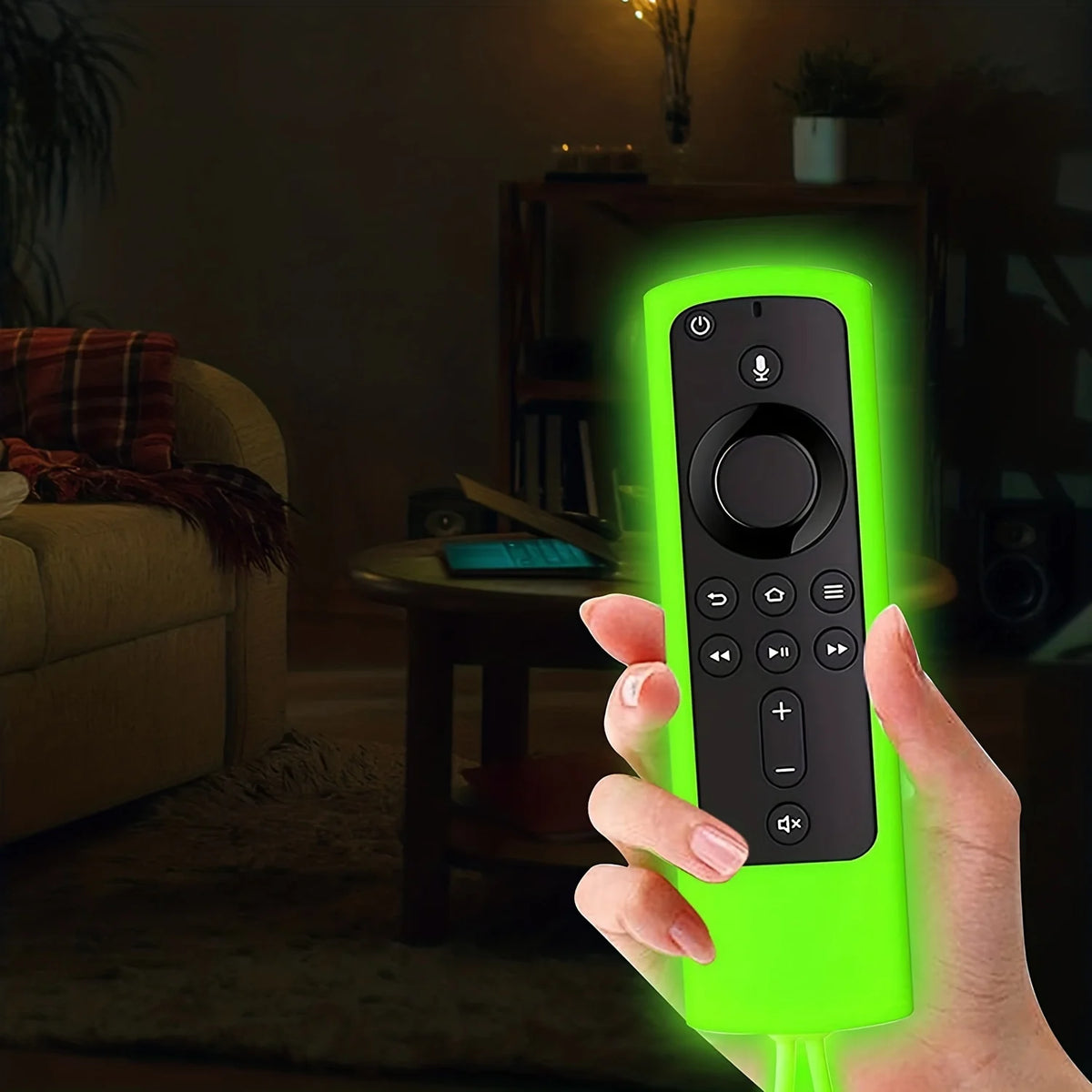 A hand holds a bright green silicone remote cover for a Fire TV Stick, glowing in a dimly lit living room.