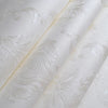 Roll of white embossed damask wallpaper featuring delicate floral scroll designs.