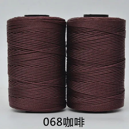 Two spools of dark reddish-brown 3-ply polyester knitting yarn for crochet and hand crafts
