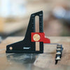 A black precision aluminum height setting gauge with a red block and a metal rod, used for measuring depth on woodworking equ