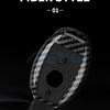 A close-up view of a black carbon fiber style car key cover.