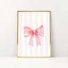 Pink bow canvas print featuring vertical stripes in soft pink and white on a gold frame.