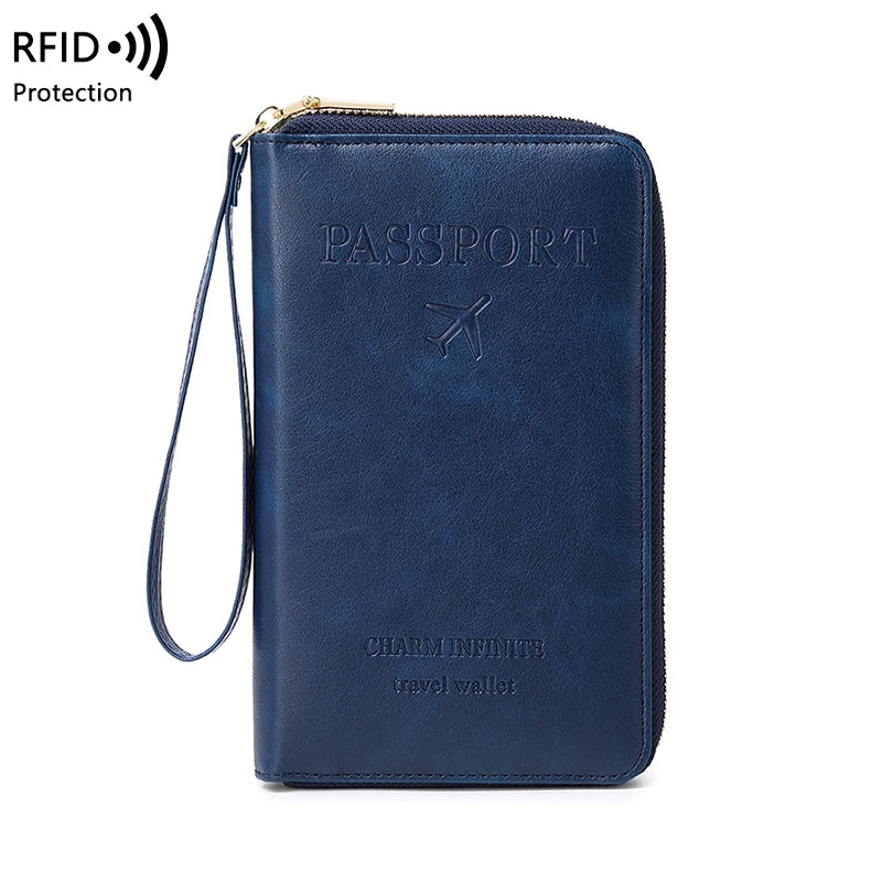 A dark blue passport RFID-blocking travel wallet with a gold clasp and wrist strap.