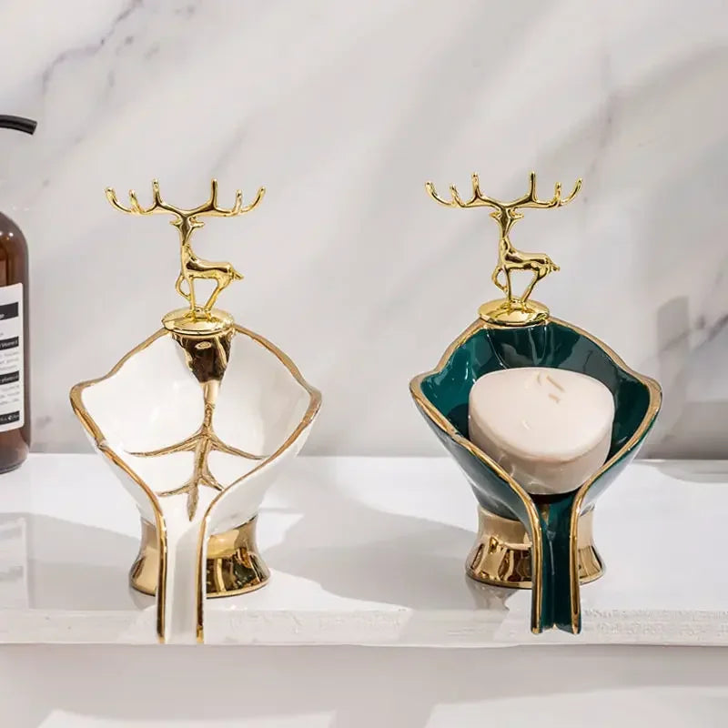 Gold-rimmed leaf-shaped ceramic soap dish with a deer drain rack
