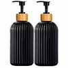 A pair of black glass and wood refillable soap dispensers.
