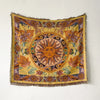 A richly colored bohemian jacquard woven throw blanket featuring a central sun motif and floral patterns.
