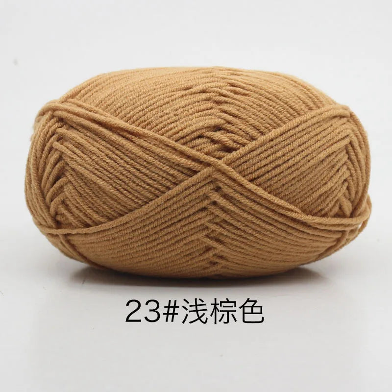 A ball of tan colored 4-ply milk cotton yarn for knitting and crochet