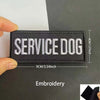 Black embroidered patch with white text SERVICE DOG and reflective details