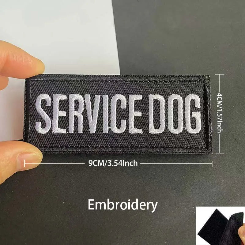 Black embroidered patch with white text SERVICE DOG and reflective details