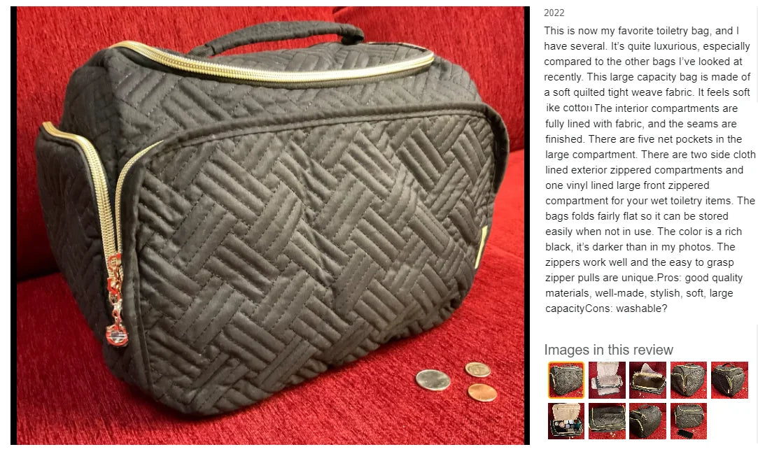 A dark quilted toiletry bag with a gold zipper and handle resting on a red fabric surface.