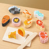 A set of wooden pretend play cutting fruit and vegetable toys in various colors and shapes on a light wooden surface.
