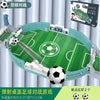A green tabletop soccer game set featuring a field, goal, and a soccer ball, packaged for family fun.