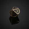 A bronze metal polyhedral dice set, likely a d10, is shown resting on a reflective surface.