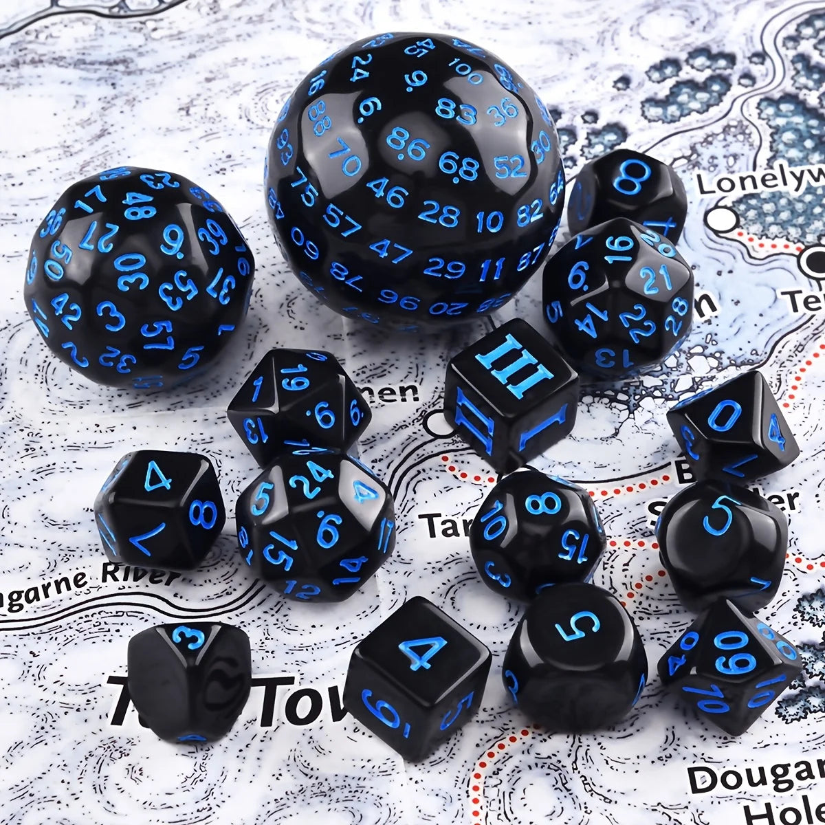 A collection of 15 polyhedral dice in various sizes and colors scattered on a white surface.